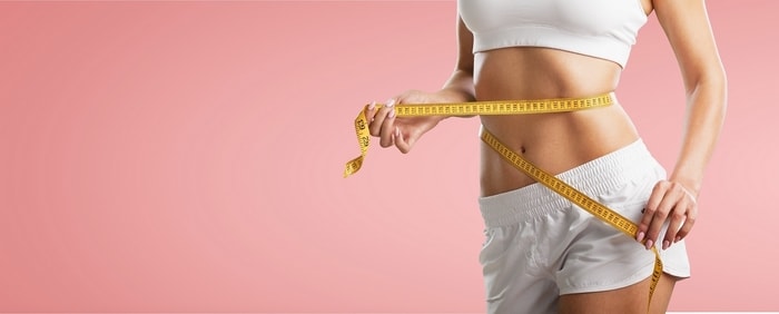 woman with tape measure around waist